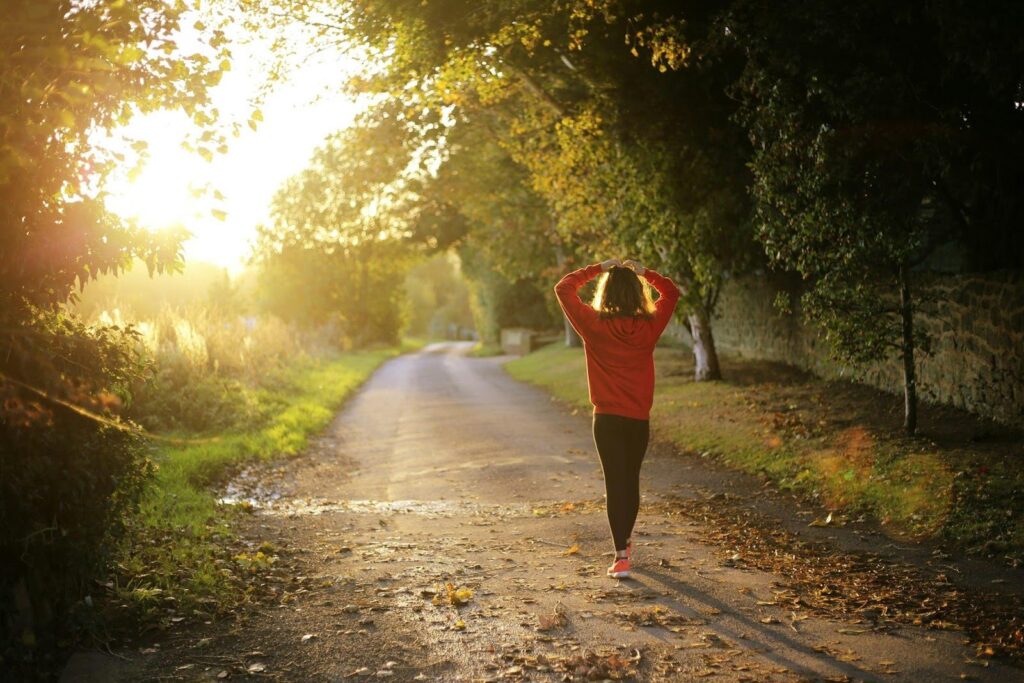 woman and veteran walking in the woods, showing how mental health and staying active are an important part of mental health treamtent, covered by Optum VA CCN mental health rehab insurance