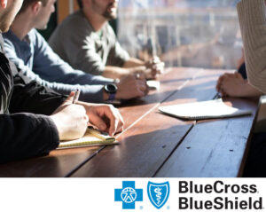A group of people with substance use disorders learning about how Transformations Treatment Center is a rehab that accepts BlueCross BlueShield insurance coverage for addiction treatment